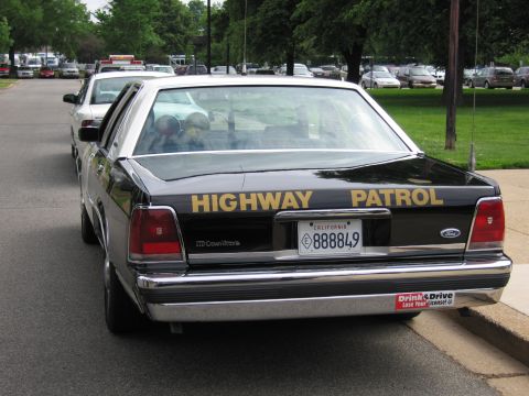 1991 Ford LTD Crown Victoria - Rear view of a black Ford Crown Victoria lettered HIGHWAY PATROL with a California plate 888849 and Don't Drink & Drive sticker.