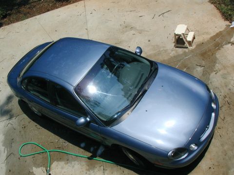 1999 Ford Taurus - A blue sedan is viewed from a high angle, showing its overall shape. The specific year and model are not identifiable from the image.