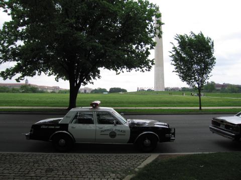 1991 Ford LTD Crown Victoria - black-and-white Jasper Police cruiser marked Street Crime Unit parked along a curb near the Washington Monument.