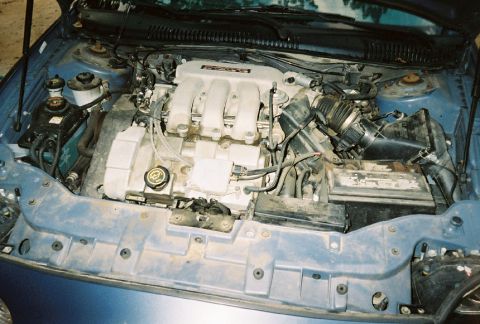 1999 Ford Taurus - A view of the engine bay, showing multiple parts and wiring.