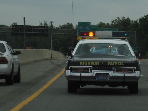 1991 Ford LTD Crown Victoria - rear of a Dodge marked HIGHWAY PATROL drives an interstate near Alexandria, with green I-95/I-395 overhead signs above.