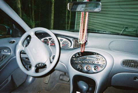 1999 Ford Taurus - Interior view of a car's dashboard, showing the steering wheel and instrument cluster.