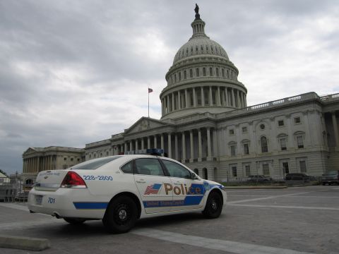 1991 Ford LTD Crown Victoria - Rear three-quarter view of a white U.S. Capitol Police Chevrolet patrol car parked before the Capitol dome.
