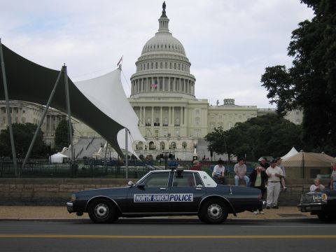 1991 Ford LTD Crown Victoria - dark blue sedan lettered North Haven Police sits curbside in front of the U.S. Capitol with onlookers nearby.
