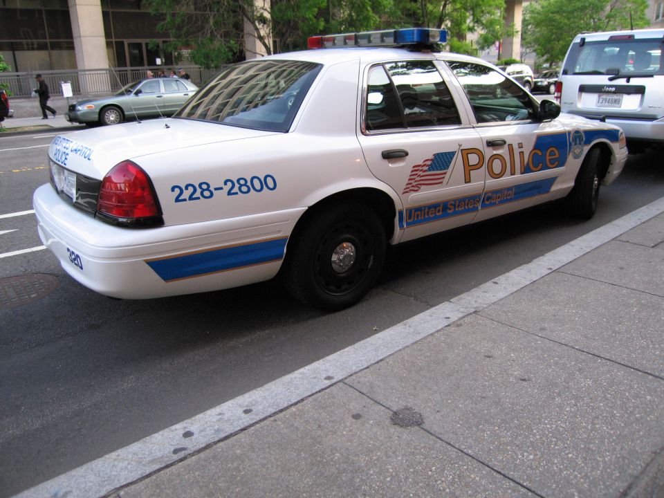 White United States Capitol Police Ford sedan parked at a curb