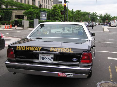 1991 Ford LTD Crown Victoria - Rear view of a black Ford Crown Victoria patrol car lettered HIGHWAY PATROL with a California plate reading 888849.