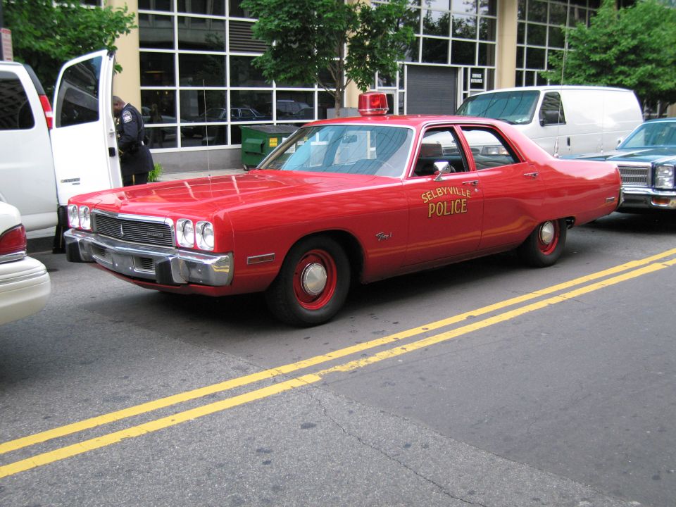 Red Selbyville Police sedan with roof beacon, front quarter view