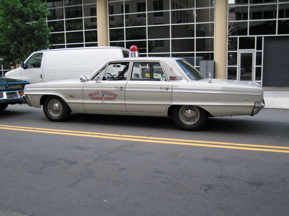 Cream Monroe County Police Reserve sedan, profile view