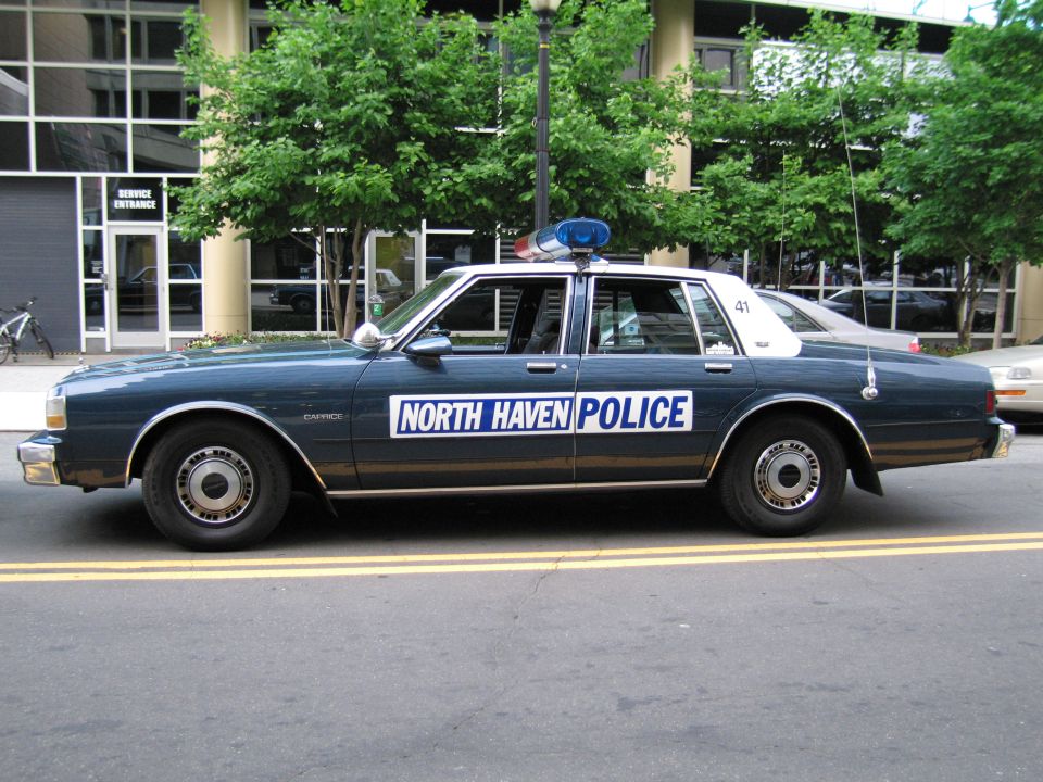 Green North Haven Police sedan, driver-side profile