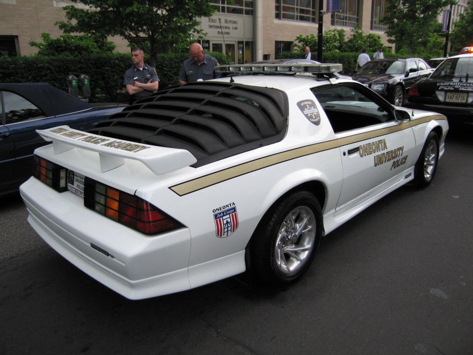 White Oneonta University Police coupe, rear view with light bar
