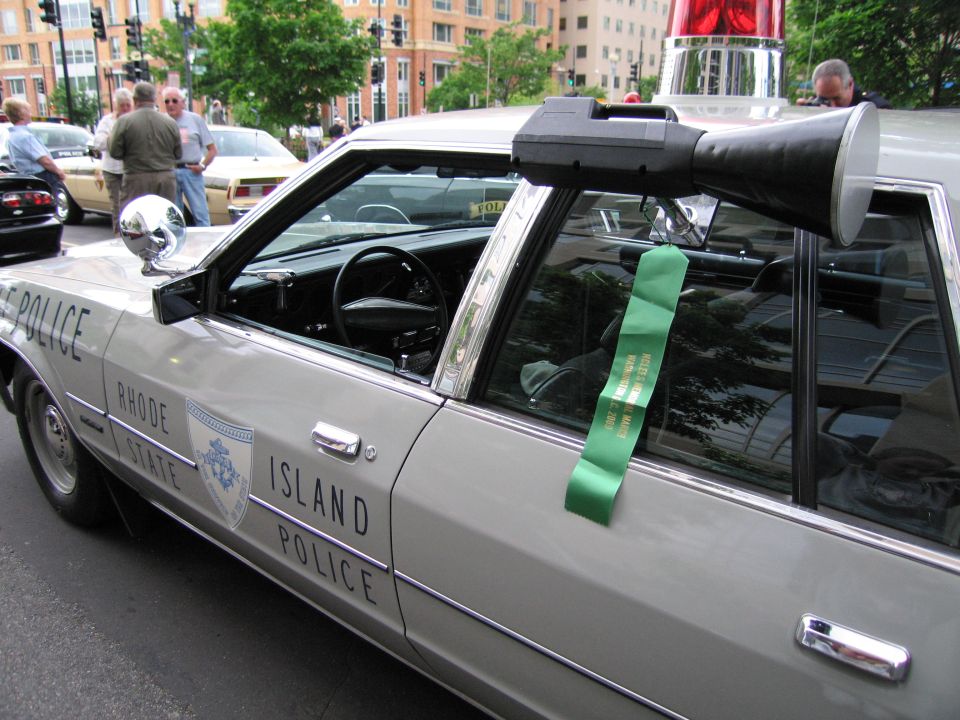 Rhode Island State Police sedan with spotlight and green ribbon