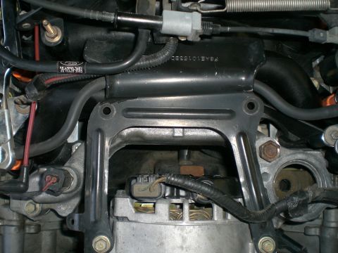 2000 Mercury Grand Marquis - Engine components visible, including a black intake manifold with Ford branding and part number F8AE-9G284-SC.