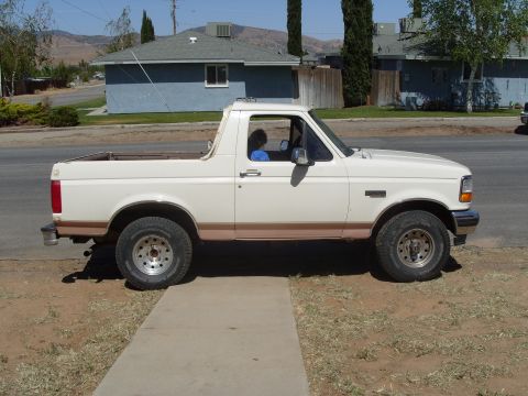 1995 Ford Bronco - This 1995 Ford Bronco is seen from the side, its distinctive two-tone paint scheme and off-road tires.