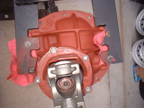 1970 Ford Torino - Close-up view of a red differential housing with a driveshaft yoke attached, held in place by a black bracket.