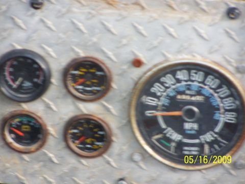 1982 Ford Bronco - Close-up of a vehicle's dashboard showing multiple gauges and a date stamp.