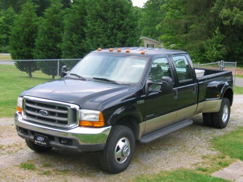 1992 Ford Mustang - 1999 Ford F-350 Super Duty crew cab dually pickup truck with a two-tone paint scheme.