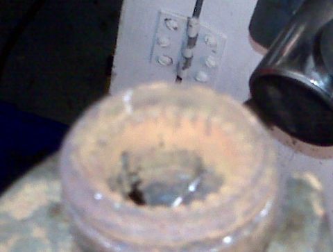1995 Ford Bronco - A close-up view of a dirty engine component stored in a clear container.