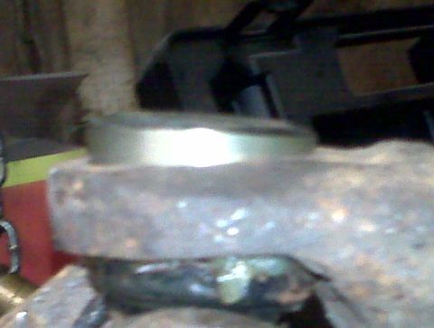 1995 Ford Bronco - A close-up view of a rusty metal component with a silver band, possibly from a vehicle's undercarriage.