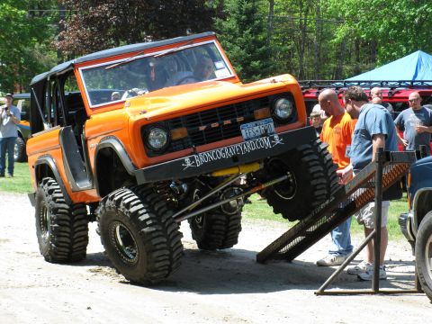 1973 Ford Bronco - Modified 1973 Ford Bronco with extreme off-road tires is being loaded onto a ramp.