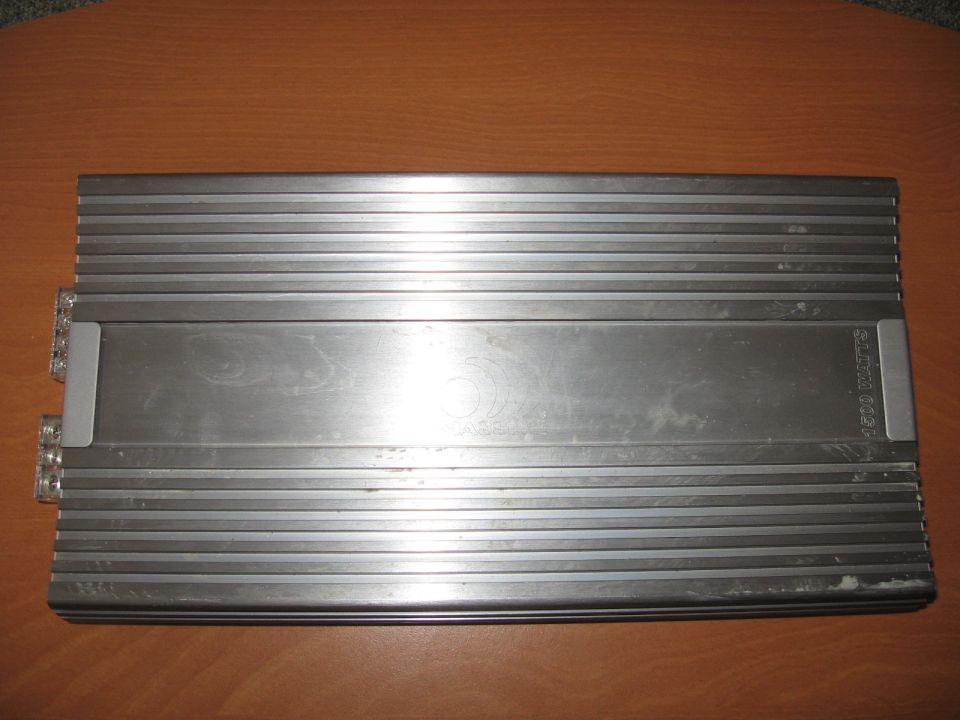 Silver car amplifier with heatsink fins and '1200 WATTS' text