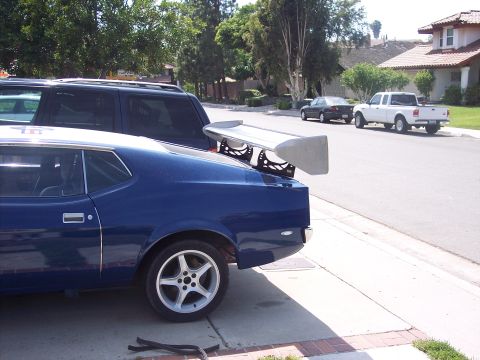 1971 Ford Mustang - The rear spoiler on this blue coupe is mounted high above the trunk lid.
