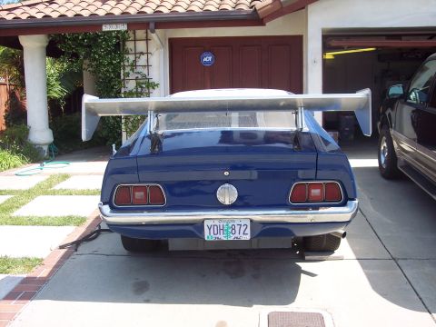 1971 Ford Mustang - Rear view of a blue 1971 Ford Mustang a large aftermarket spoiler and a custom Oregon license plate.