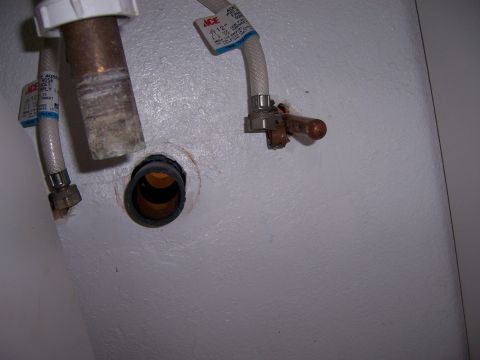 1991 Ford Bronco - Close-up of plumbing connections and supply lines under a sink.