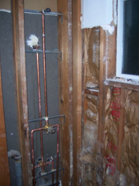 1991 Ford Bronco - Rough plumbing is installed in a bathroom wall, with insulation visible in the background.