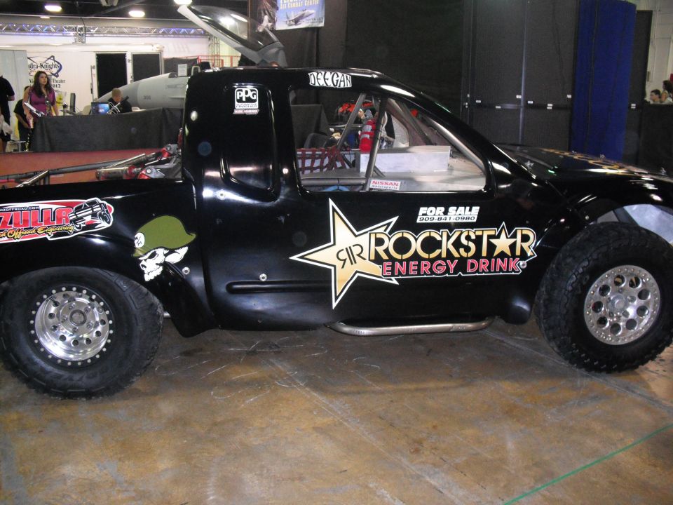 Black custom truck with Rockstar Energy Drink decals and a skull with a helmet graphic