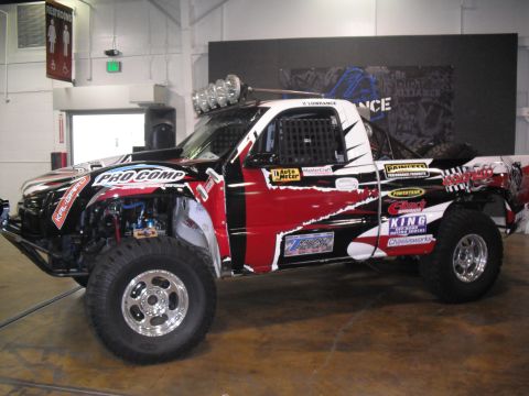 1986 Ford Bronco - This custom off-road truck features extensive Pro Comp branding and modifications for extreme motorsports.