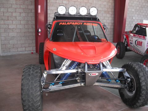 1986 Ford Bronco - This custom off-road buggy features a prominent front suspension and a roof-mounted light bar.