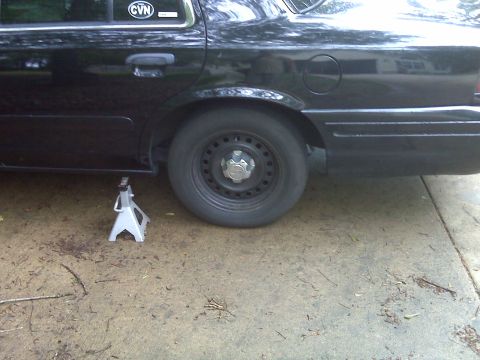 2001 Ford Crown Victoria - Rear wheel of a 2001 Ford Crown Victoria supported by a jack stand.