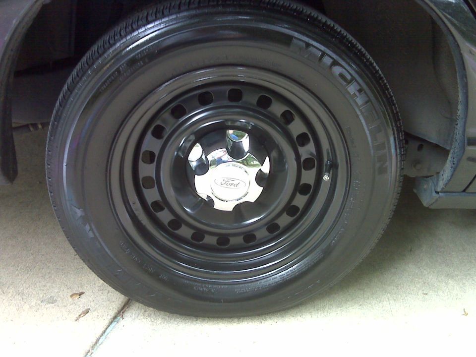 Black steel wheel with Ford logo center cap and Michelin tire