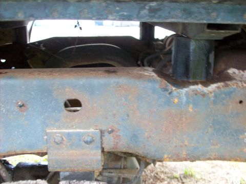 1985 Ford F-250 - Close-up view of heavily rusted truck frame and undercarriage components.