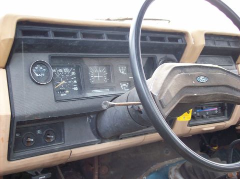 1985 Ford F-250 - The interior of a 1985 Ford F-250, its dashboard instrumentation and steering wheel.