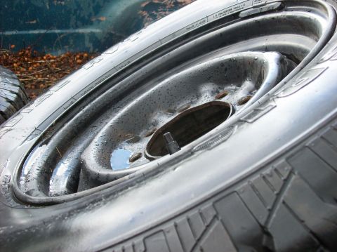 1985 Ford F-250 - Steel wheel and tire assembly, likely for a truck or SUV.