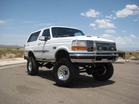 1996 Ford Bronco - This lifted 1996 Ford Bronco is shown from the front three-quarter view on a sunny day.