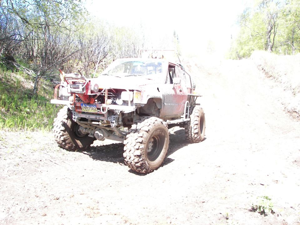 Modified off-road truck with large tires and custom bumper