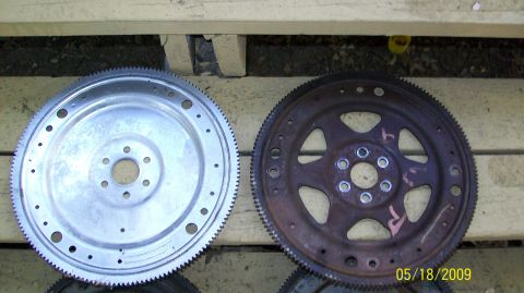 1973 Mercury Cougar - Two flexplates are shown, one appearing new and the other showing signs of rust and wear.