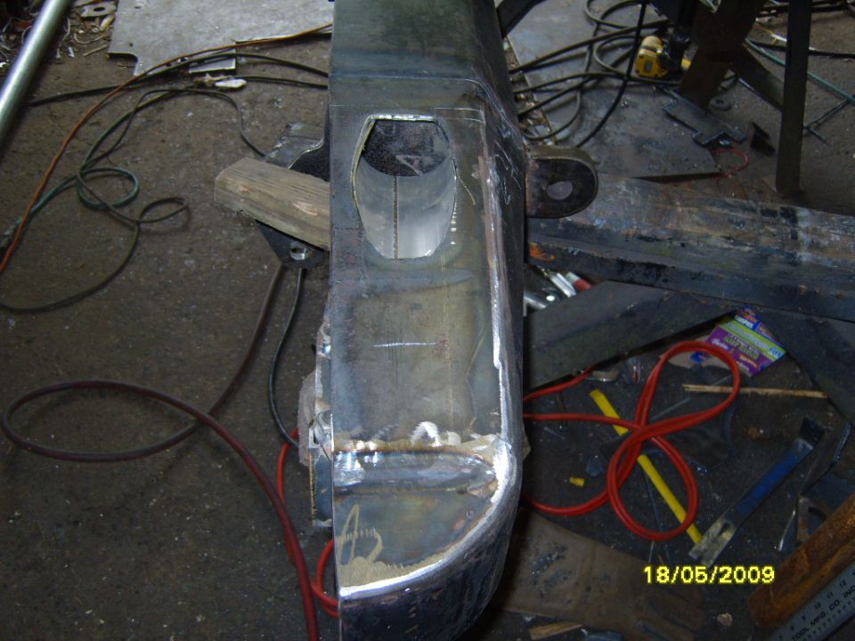 Custom rear bumper section with cutouts and welding marks