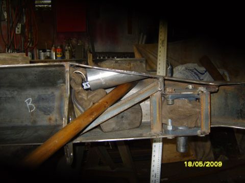 1989 Ford Bronco - Close-up of metal fabrication work on a vehicle's chassis, showing structural components and welding.