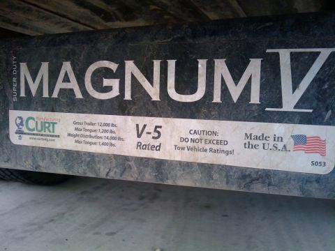 1994 Ford Bronco - This trailer hitch features "MAGNUM IV" branding and "CURT" manufacturing details, including weight capacity information.