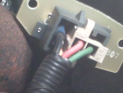 1995 Ford Bronco - Close-up of an electrical connector with colored wires, possibly from a vehicle's interior components.
