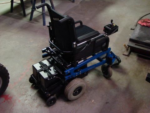 1948 Jeep Wrangler - This electric wheelchair has a blue frame and large, rear tires.