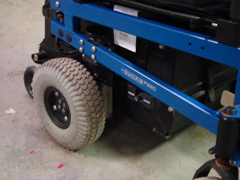 1948 Jeep Wrangler - A blue power wheelchair with a prominent tire and visible model name "QUICKIE P320" is shown.
