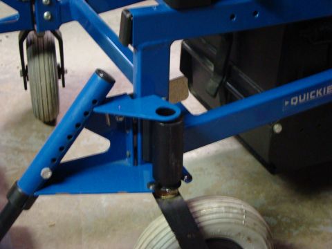 1948 Jeep Wrangler - Close-up view of a blue metal frame with wheels and a black box, showing the "Quickie" logo.