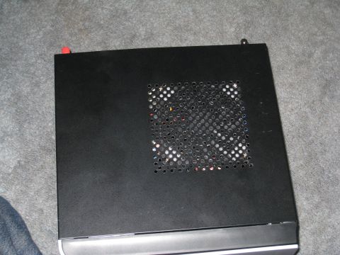 2007 Subaru Impreza - A black computer case sits on a carpeted surface, showing ventilation holes and two small knobs.