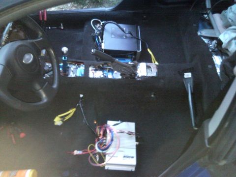 2007 Subaru Impreza - The interior of a car is shown with the dashboard disassembled, revealing wiring and audio components.