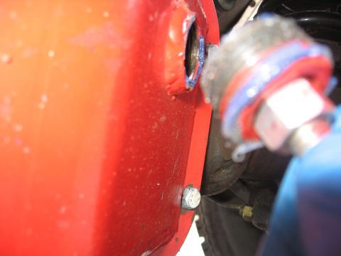 1989 Ford Bronco - A close-up shot shows a fitting being attached to a red automotive component.