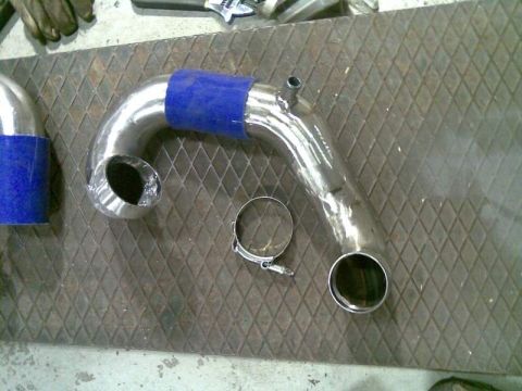 1969 MINI Cooper - Custom intercooler pipe assembly with a blue silicone coupler and a hose clamp is laid out on a textured surface.